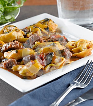 Braised beef and portobello tortelloni photo