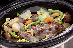 Braised beef pot roast stew with vegetables on table