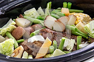 Braised beef pot roast stew with vegetables on table