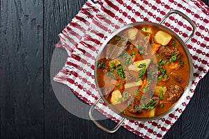 Braised beef with potato and carrots photo