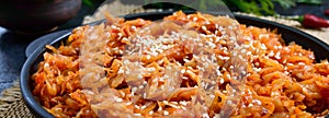 Braised cabbage from tomato sauce in a cast-iron frying pan on a black background. Lenten menu. Diet low-calorie vegetable dish.