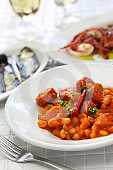 Braised with chorizo and white kidney beans, spanish tapas food photo