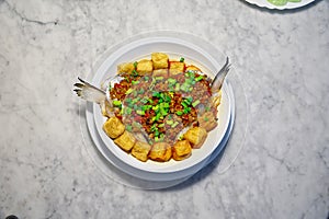 Braised fish with fried yellow tofu on dish, Chinese food, homemade tasty food, top view