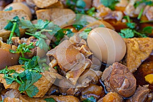 Braised pig\'s trotters, eggs with brown soya sauce, coriander,Chinese herbs, rice wine ,tofu and black vinegar. Traditional