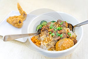 Braised pork rice and egg and in sweet brown sauce with fried chicken wings delicious food in Singapore