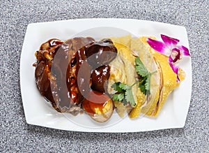 Braised Pork Trotter with hai nam chicken in thai style with sauce served in dish isolated on grey background top view of hong