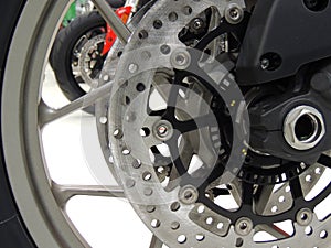 Brake disc on the front wheel of sport motorcycle at moto shop stock photo