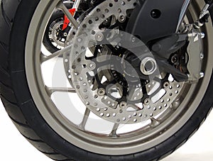 Brake disc on the front wheel of sport motorcycle at moto shop stock photo