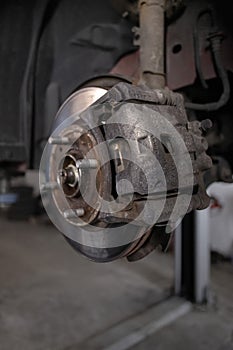 Brake pad on a car disc close-up