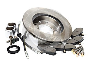 Brake parts on white: brake pads, disc, brake hose, guides, cylinders