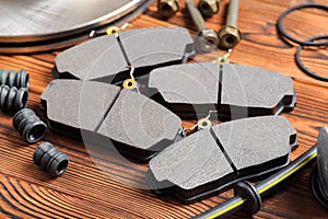 Brake parts on wooden background  brake pads, disc, brake hose, guides, cylinders- Image