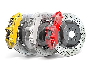 Braking system. Car brake disks with different perforations and calipers  isolated on white background