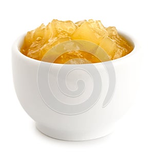 Bramley apple sauce in ceramic bowl on white.