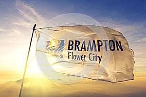 Brampton of Ontario of Canada flag waving on the top sunrise mist fog