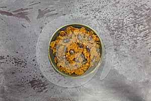 Bran flake cereal with raisins in a stoneware bowl