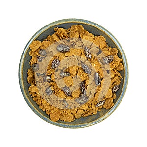 Bran flake cereal with raisins in a stoneware bowl