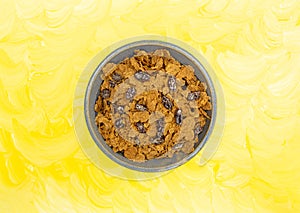 Bran flake cereal with raisins in a stoneware bowl