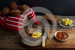 Bran muffins with cheese and apricot jam with butter knife