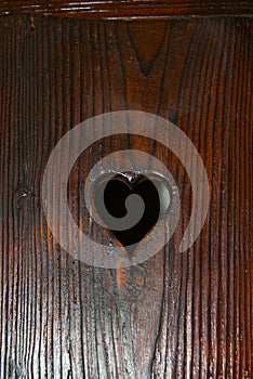 Bran, Romania: A door with a hole in the shape of a heart. The Interior of the medieval Bran Castle, home of Vlad Tepes Dracula,