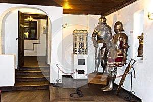 Interior rooms of the medieval Bran Castle in Romania. Antique Knight Armor at Dracula`s Castle