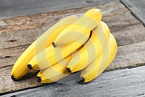 Branch of bananas on the rustic background. Selective focus. Shallow depth of field.
