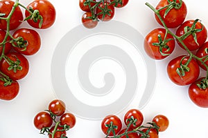 Branch of beautiful juicy organic red cherry tomatoes on white background.