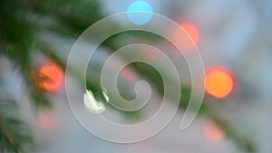 branch of a Christmas tree on a background of Christmas lights new year background, no focus, blur, blurry Closeup of