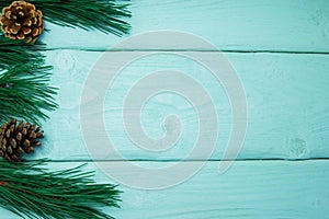 Branch christmas tree and cone on turquoise wooden vintage background