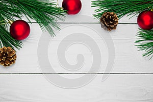 Branch christmas tree and red ball with cone on white wooden vintage background