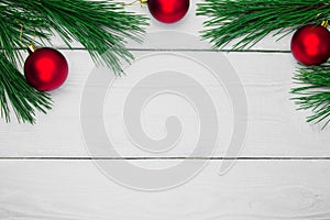 Branch christmas tree and toy ball on white wooden vintage background