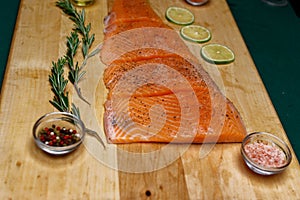 Branch of green fresh rosemary and peppery salmon fillet