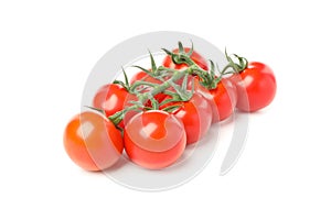 Branch of red tomatoes isolated on white