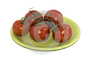 Branch of red tomatoes on a lime plate