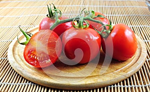 Branch tomatoes on wooden board