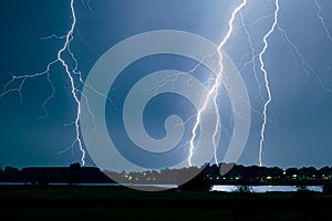 Branched lightning strikes close to a river