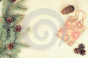 Branches of blue spruce, cones and paper shopping gift bag