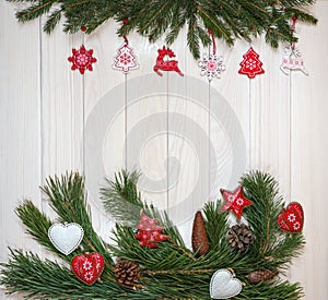 Branches of a Christmas tree, New Year`s decor on a light wooden background. Close-up. Design for postcards, banner.