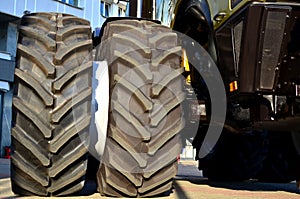 Brand new big tires placed with a large protector,  mounted on a agricultural combine tractor