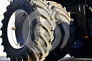 Brand new big tires placed with a large protector,  mounted on a agricultural combine tractor