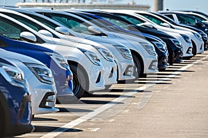 Brand new cars lined up in a parking lot