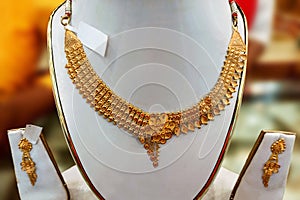 A brand-new design gold necklace is kept as a model in a jewelry shop for exhibition