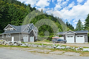 Brand new family house with car and boat parked on gravel driveway