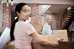 Brand new home, here we come. Shot of a young woman helping her elderly mother move house.