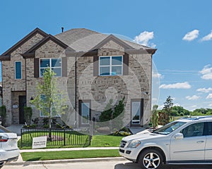 Brand new model house with cars on street near Dallas, Texas