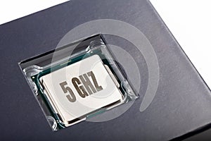 Brand new modern no name silver cpu 5 ghz processor die, chip plastic packed top lid view macro closeup. New tech prop