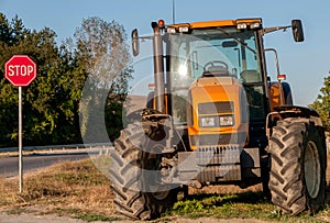 Brand new orange tractor at the end of the village