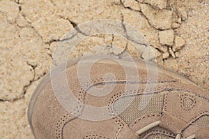Brand new suede and nylon beige tan camo military tactical desert combat boot, arid dried soil sand detailed horizontal background