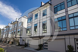 Brand new townhouse complex. Rows of townhomes side by side. External facade of a row of colorful modern urban townhouses. brand n