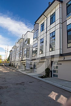 Brand new townhouse complex. Rows of townhomes side by side. External facade of a row of colorful modern urban townhouses. brand n