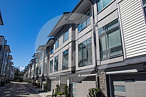 Brand new townhouse complex. Rows of townhomes side by side. External facade of a row of colorful modern urban townhouses. brand n